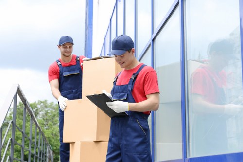 Specialist team handling an upright piano move with care