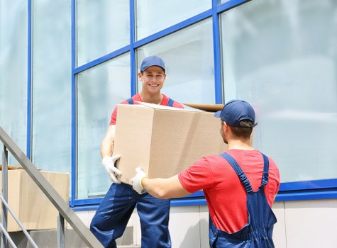 Furniture being carefully carried from an apartment staircase