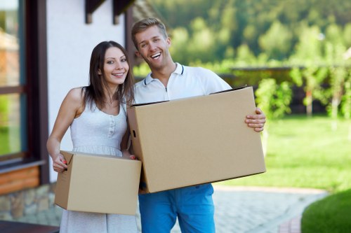 Professional movers handling office furniture and IT equipment