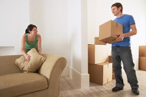 Packed moving boxes and furniture ready for transport in Edgware